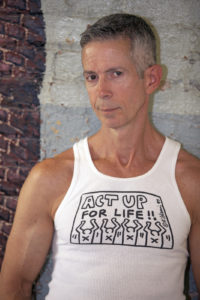 Peter Staley photographed at NYC's LGBT Community Center in front of a Martin Wong wall painting. Wong died in 1999 from an AIDS related illness.