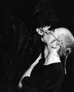 Tigger, ACT UP Amsterdam, 1992, black and white, selenium-toned silver gelatin print, 16 by 20 inches (photographed at the VIII International AIDS Conference in Amsterdam; with Mr. Death, a large Carnival puppet who made his appearance in the Convention Hall where drug manufacturers had set up exhibition booths) 