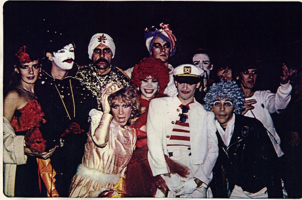 My friends in NYC, 1980: “Richard Cheney, in his Pierrot, and Ron Baretta in his Swami exotic. Richard made these costumes. They were professional. Good enough for Broadway. He did that all the time. Out of these friends, five died of AIDS in the next six years, two are positive, one died of cancer, and the others unknown. At the time this photograph was taken we were still having the time of our lives. No one knew they had AIDS or HIV.” Photo courtesy S. Lewis